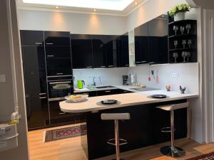 a kitchen with black cabinets and a white counter top at Budapest, Graf Teleki Laszlo Appartement in Budapest