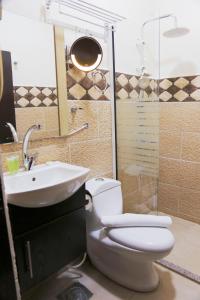 a bathroom with a toilet and a sink at Plaza View Hostel in Taiyiba