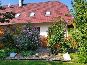 a house with a red roof and some flowers at Ferienwohnung Halle in Halle