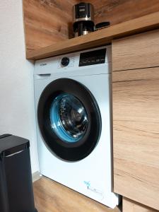 a washing machine sitting inside of a cabinet at Hotel Weibertreu in Weinsberg