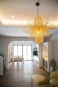 a living room with a dining table and a chandelier at Twelve Stones at Wahoo KBP in Padalarang