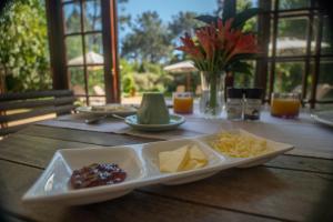 a wooden table with a plate of cheese and chips at Silvermist Wine Estate in Cape Town
