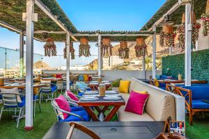 a patio with tables and chairs on a roof at Alina 203a @ Morgan Residences in Cabo San Lucas