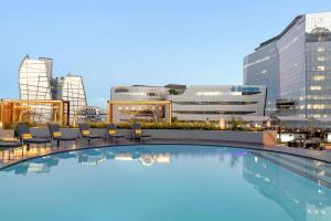 a swimming pool on the roof of a building with buildings at Sandton Sun and Towers in Johannesburg