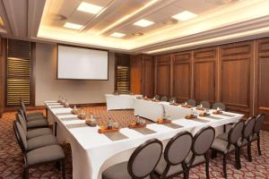 a large conference room with a long table and chairs at Sandton Sun and Towers in Johannesburg