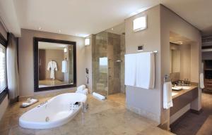 a large bathroom with a tub and a shower at Sandton Sun and Towers in Johannesburg