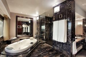 a large bathroom with a tub and a shower at Sandton Sun and Towers in Johannesburg
