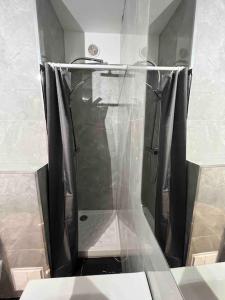 a shower in a bathroom with a shower curtain at Studio bord de Mer - Proche Aéroport de Nice in Saint-Laurent-du-Var