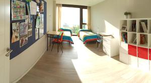 a room with two beds and a desk in it at Casa con vistas al mar en Pontevedra in Pontevedra