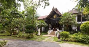 a house with a garden in front of it at Radateeree Boutique Resort in Chiang Mai