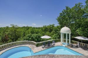 a swimming pool with a gazebo next to a swimming pool at Beautiful Château with Private Pool near Cahors in Cambayrac