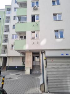 een appartementencomplex met een garage ervoor bij Golden Sun Skopje in Skopje