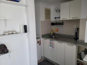 a kitchen with white cabinets and a sink at Dalaman Botanik Garden in Dalaman