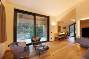 a living room with a large window and a dining room at Valgrisa Mountain Lodges 1 in Valgrisenche