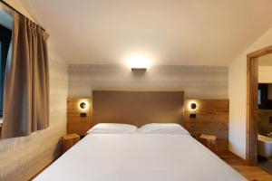 Postel nebo postele na pokoji v ubytování Valgrisa Mountain Lodges 1