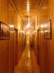 a long hallway with wooden walls and a wooden floor at WOOD MOTEL in Mingachevir