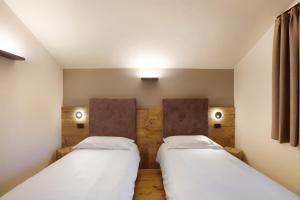 Postel nebo postele na pokoji v ubytování Valgrisa Mountain Lodges 1