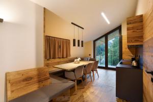 a kitchen and dining room with a wooden table and chairs at Valgrisa Mountain Lodges 1 in Valgrisenche