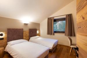 Postel nebo postele na pokoji v ubytování Valgrisa Mountain Lodges 1