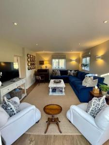 un soggiorno con 2 divani e un divano blu di Northbrook Cottage, Farnham, up to 8 adults a Farnham