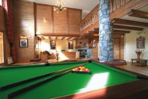 a pool table in the middle of a room at Vanoise Express Property (Paradiski) in Peisey-Nancroix