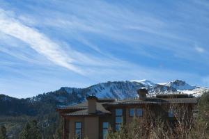 a house with a mountain in the background at Aspen Creek by 101 Great Escapes in Mammoth Lakes