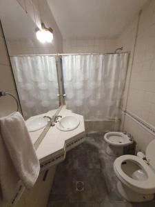 a bathroom with two sinks and a toilet and a shower at Loft con todo que necesitas solo a 2 cuadras de la costanera!! in Corrientes