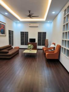 a living room with couches and a coffee table at Teratak Qu Homestay Sijangkang in Teluk Panglima Garang