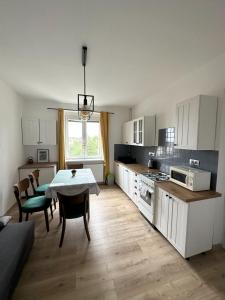 a kitchen with a table and chairs and a dining room at Apartments Old Town in Brandýs nad Labem-Stará Boleslav