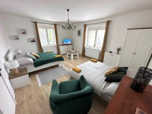 a living room with a bed and a couch at Apartments Old Town in Brandýs nad Labem-Stará Boleslav
