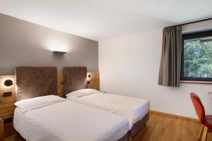 Postel nebo postele na pokoji v ubytování Valgrisa Mountain Lodges 2