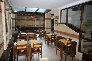an empty restaurant with wooden tables and chairs at Hotel SultanHill in Istanbul