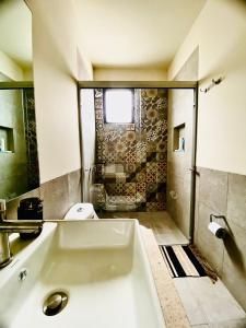 a bathroom with a white tub and a toilet at TriBeCa San Miguel in San Miguel de Allende
