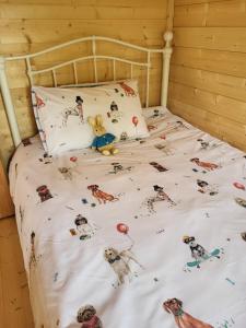 a bed with lots of pictures of dogs on it at Hot Tub Unique Farm Stay in Pallis Bridge
