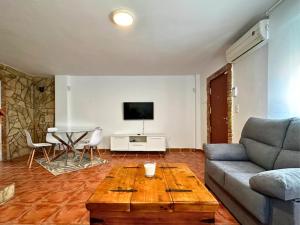 a living room with a couch and a table at Chalet en La Mata a 50 metros de la playa in Torrevieja