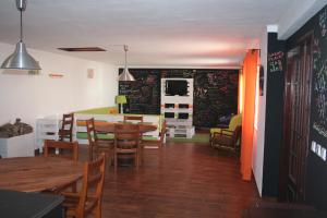 a kitchen and dining room with tables and chairs at Santa Maria do Mar Guest House in Peniche
