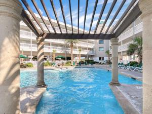 an outdoor swimming pool with a pergola at Ocean view and family vacation at Casa Del Mar in Galveston