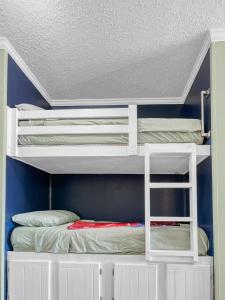 two bunk beds in a room with a ceiling at Ocean view and family vacation at Casa Del Mar in Galveston