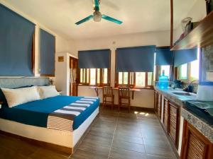 a bedroom with a bed and a kitchen at Estudio con vista al mar, AC, WIFI Starlink, Parking in San Agustinillo