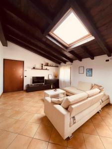 a living room with a couch and a skylight at La Mansarda - time & relax 
