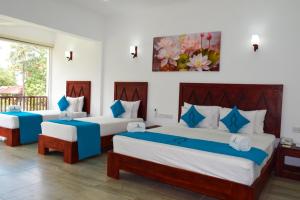 A bed or beds in a room at Anantamaa Hotel