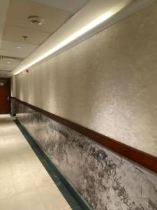 a metal wall in a hallway with at فندق منار الإيمان in Medina