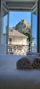 a bedroom with a view of a mountain from a window at Albatros in Lourdes