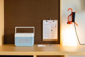 a desk with a lamp and a sign on a wall at Rhode's Motor Lodge in Boone