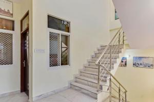a staircase in a house with a door and a window at OYO Ekta My Stay in Jaipur