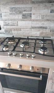 a stove top oven with four burners on it at Casa Fissore in Sommariva Perno