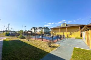 a house with a fence in front of a yard at Bonita Lakes Inn by Capital O Meridian I20 in Meridian +96 photos