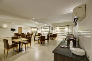 a restaurant with tables and chairs and a dining room at Saltstayz Corporate Suite- Golf Course Road and Near galleria market in Gurgaon