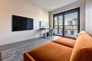 TV a/nebo společenská místnost v ubytování YUMA Apartments Leipzig Berliner Straße
