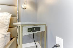 a bedside table with a clock on it next to a bed at Modern Rental - Pet-Friendly, Free Parking in Hollywood